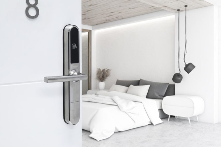 Corner of luxury minimalistic bedroom with white walls, concrete floor, master bed with two bedside tables and stylish ceiling lamps. Bathroom with shower in background. 3d rendering